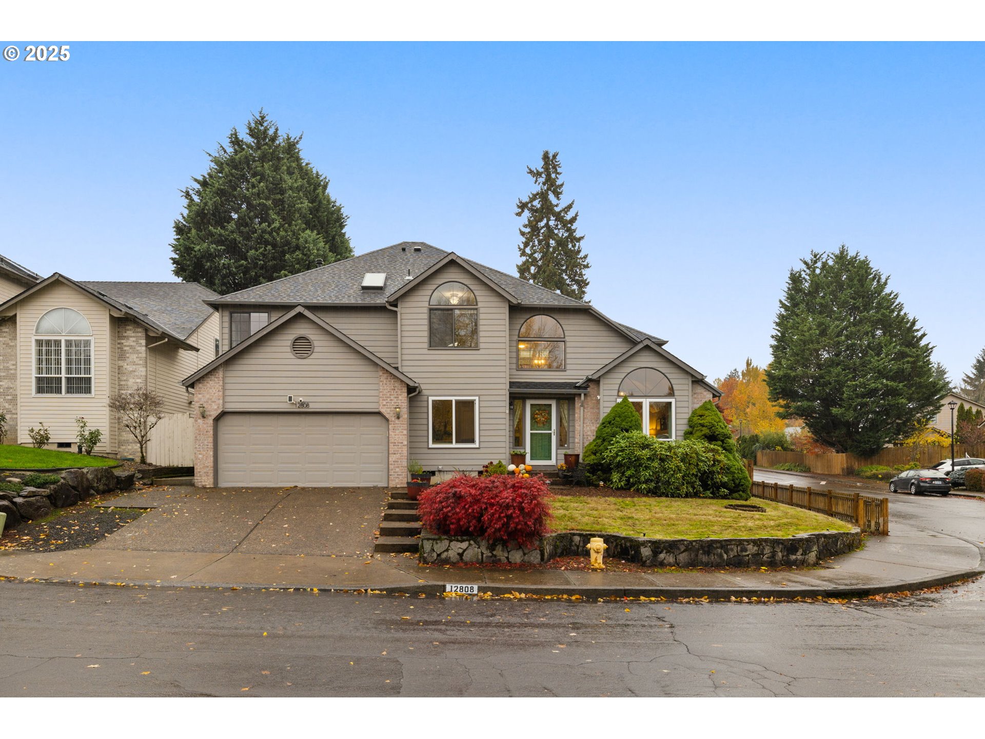 12808 Southwest Falcon Rise Drive Portland, OR 97223 - Photo 2 of 46 a view of a white house next to a yard with large trees