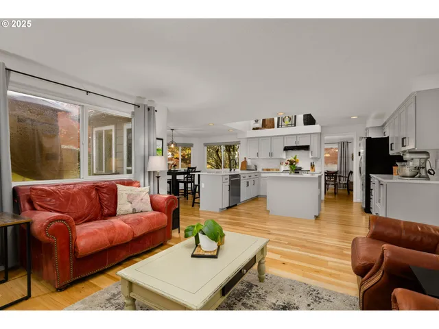a living room with furniture and a view of kitchen