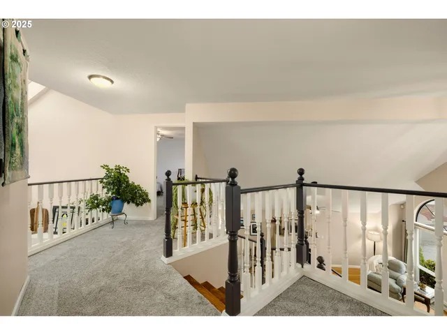 a view of a hallway with wooden floor and windows
