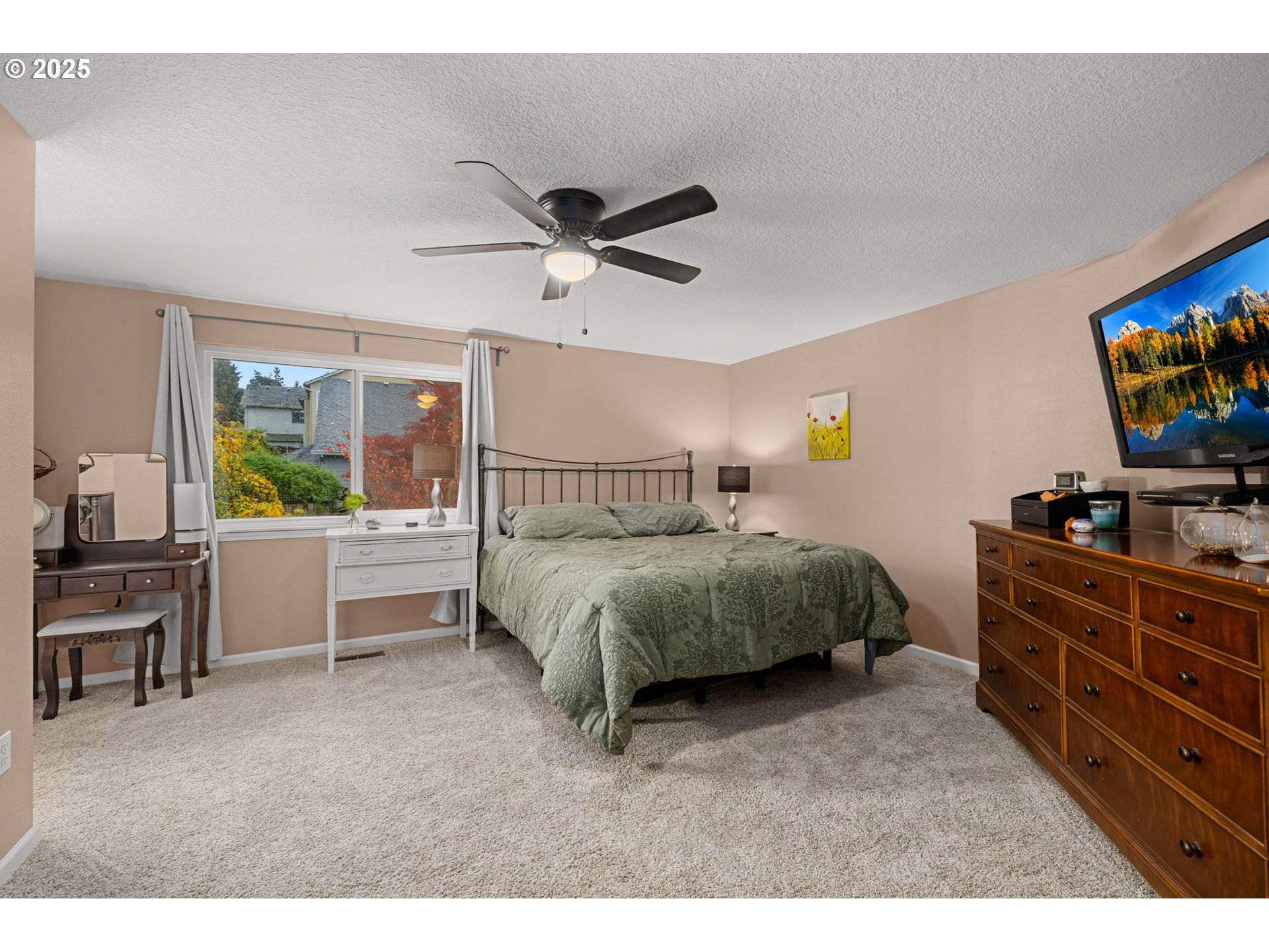 12808 Southwest Falcon Rise Drive Portland, OR 97223 - Photo 27 of 46 a bedroom with a bed a dresser and a chandelier