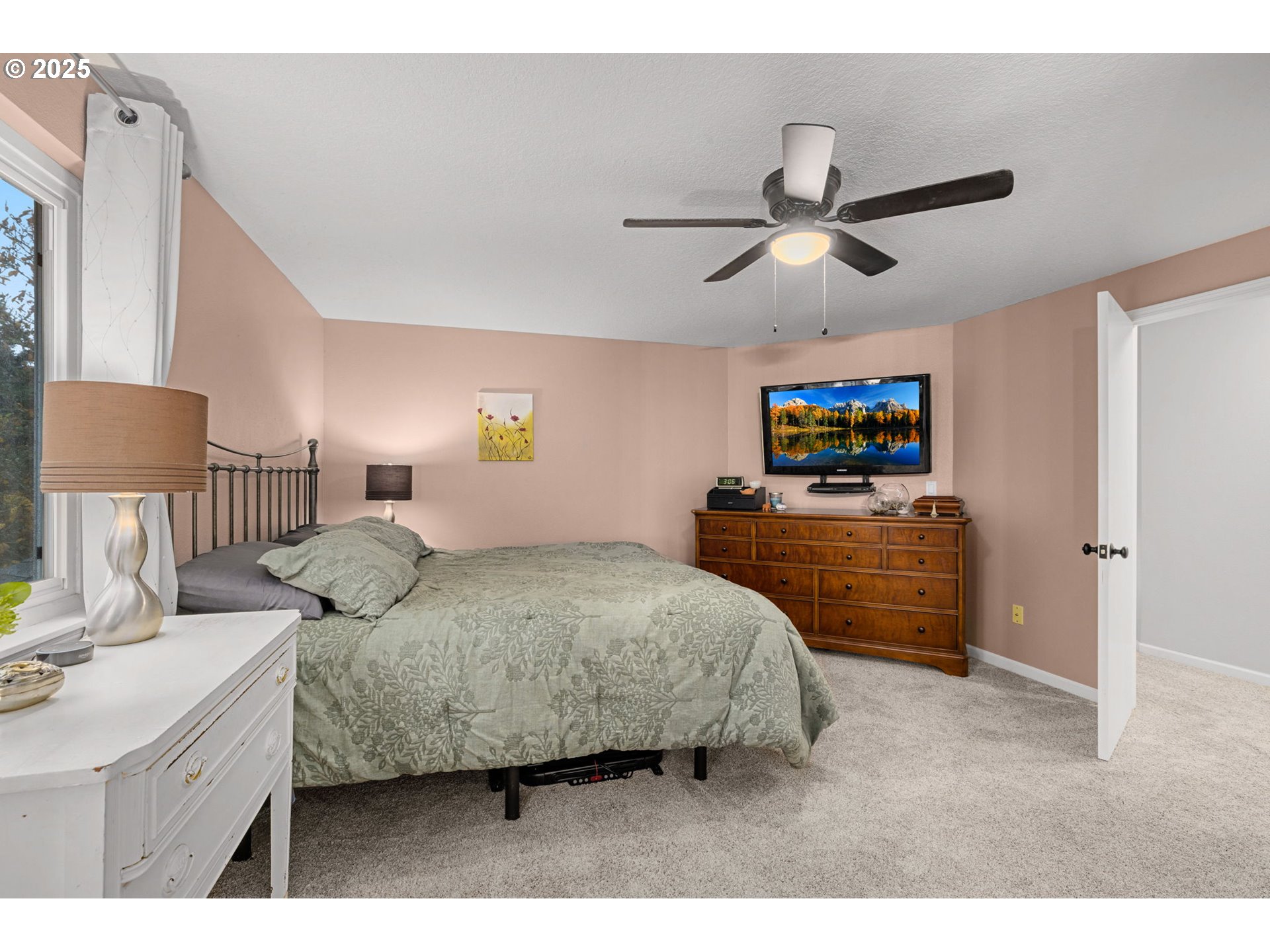 12808 Southwest Falcon Rise Drive Portland, OR 97223 - Photo 28 of 46 a bedroom with a bed and a flat screen tv