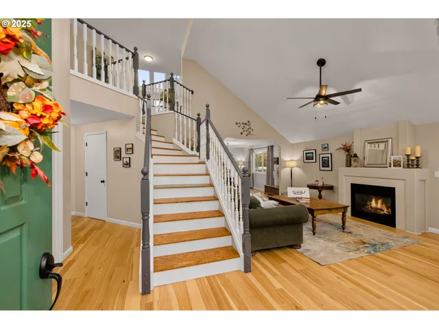 a view of a livingroom with furniture a fireplace chandeliers fan