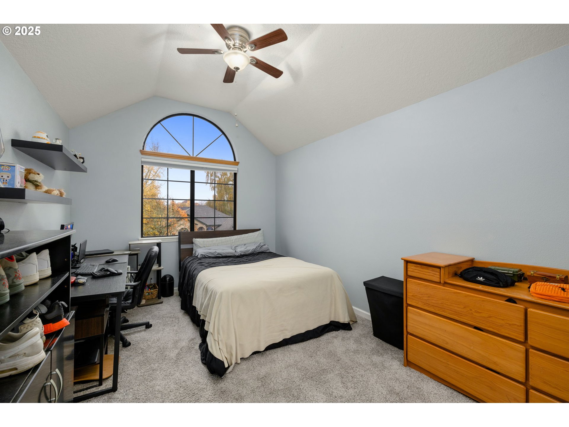12808 Southwest Falcon Rise Drive Portland, OR 97223 - Photo 36 of 46 a bedroom with a bed a dresser and book shelfs