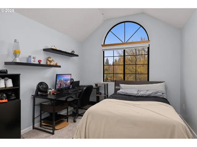 a bedroom with a bed and a window