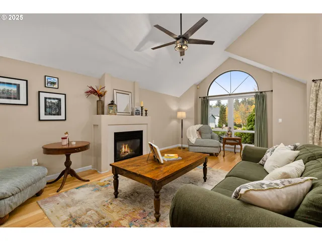 a living room with furniture a chandelier and a fireplace