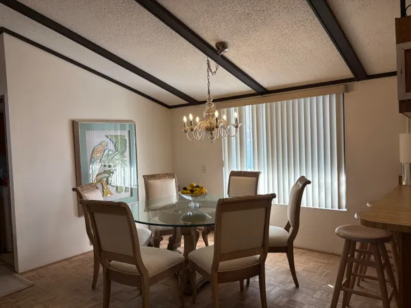a dining room with furniture and window