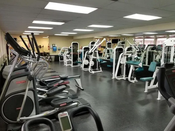 a gym room with lots of gym equipment