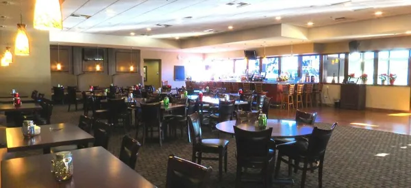 a view of a dining area with lots of bottles of alcohol