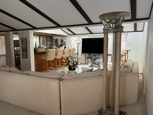 a dining room with furniture and a flat screen tv