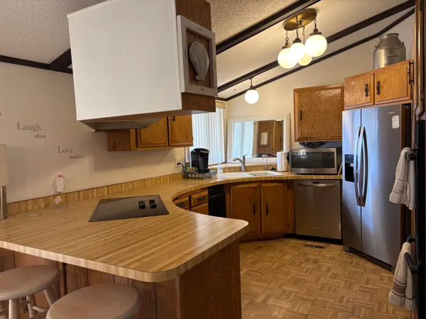 a kitchen with a sink refrigerator and cabinets