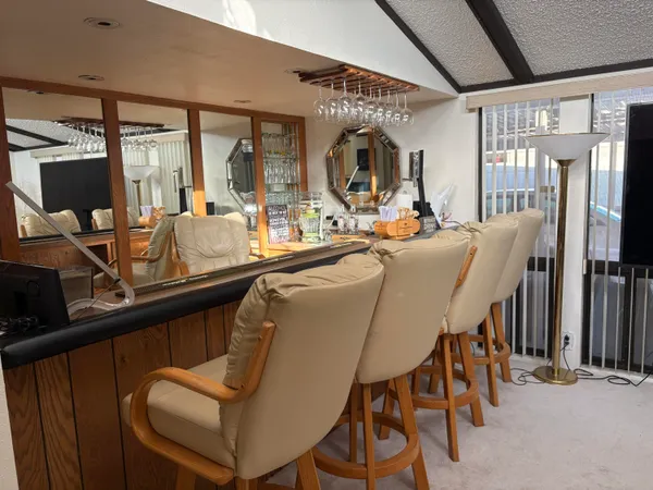 a dining room with furniture and a floor to ceiling window
