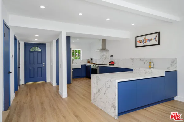 a kitchen view with granite countertop a sink and dishwasher with wooden floor