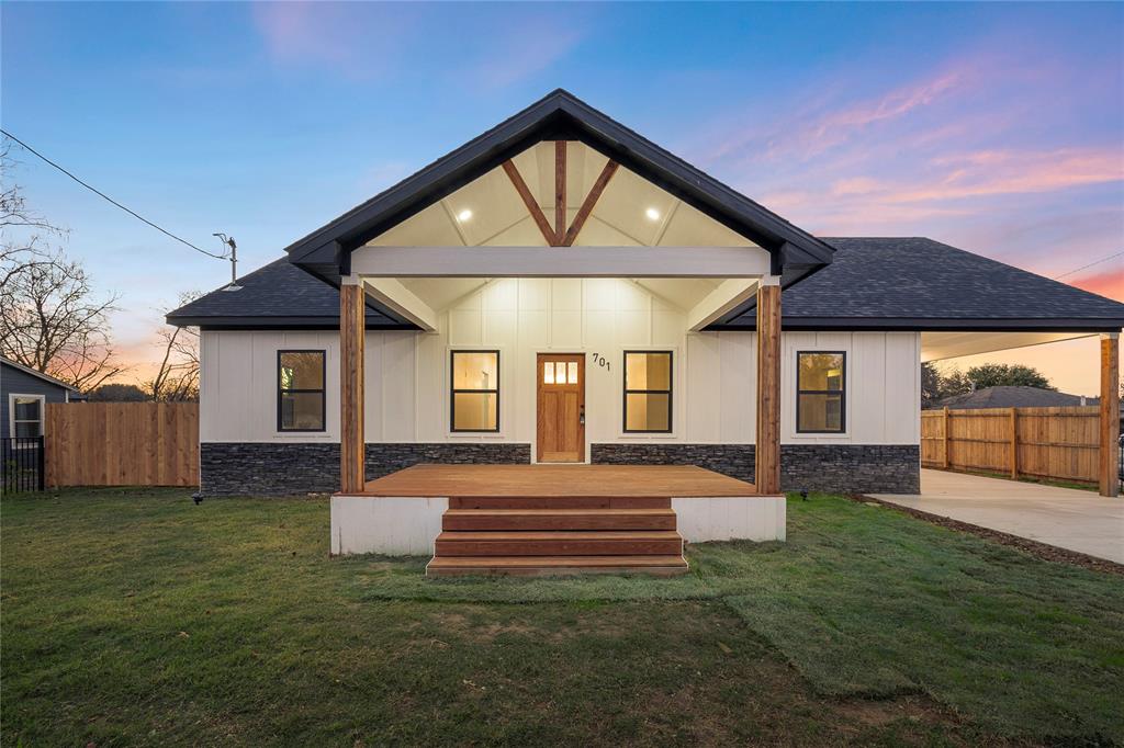 701 Haymarket Road Dallas, TX 75217 - Photo 1 of 1 Back house at dusk featuring a lawn