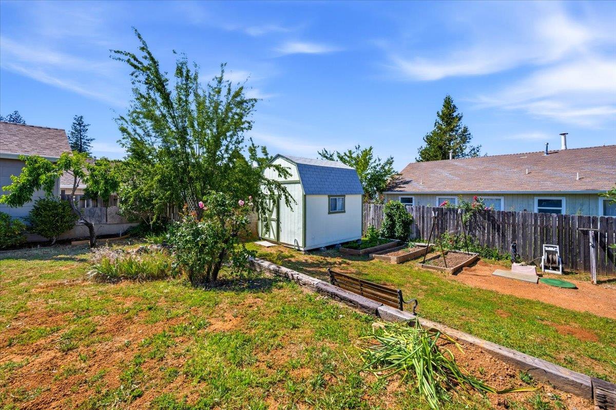 232 Upper Slate Creek Road Grass Valley, CA 95945 - Photo 32 of 48 a view of patio with lawn chairs under an umbrella