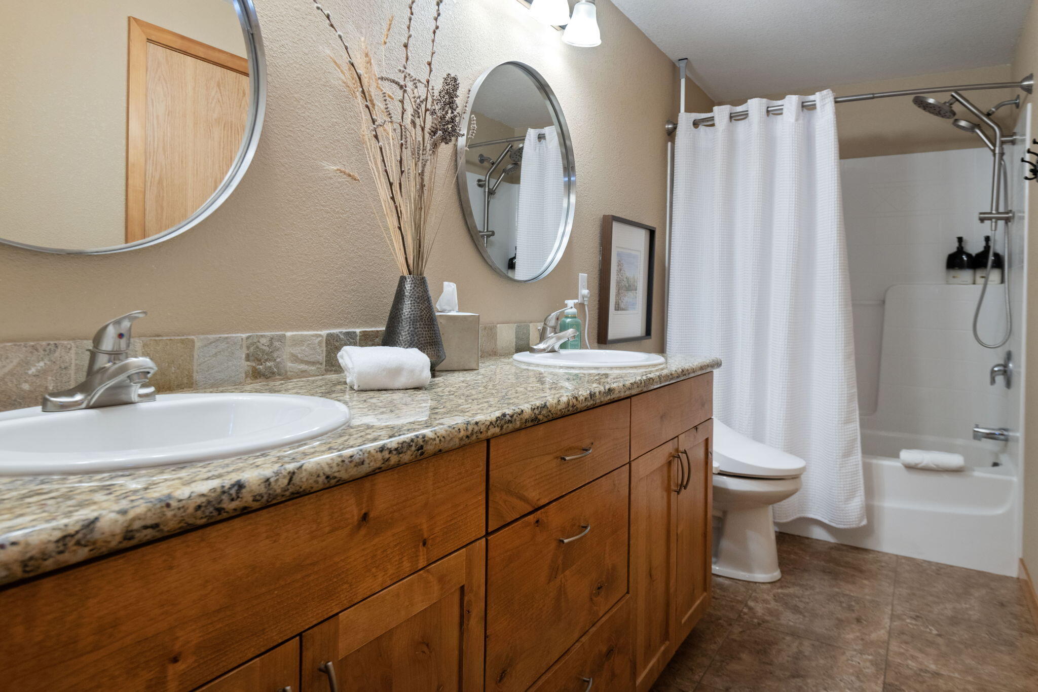 22539 Martee Lane Bend, OR 97701 - Photo 14 of 54 a bathroom with a granite countertop toilet sink and mirror