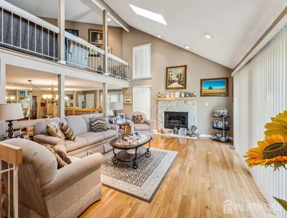 a living room with furniture fireplace and a window