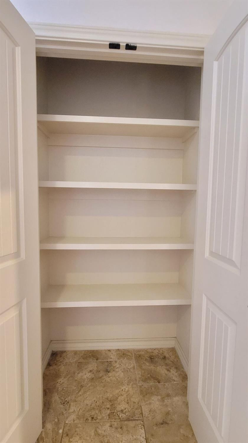 5234 Kemper Street Lubbock, TX 79416 - Photo 13 of 28 a view of walk in closet with empty racks