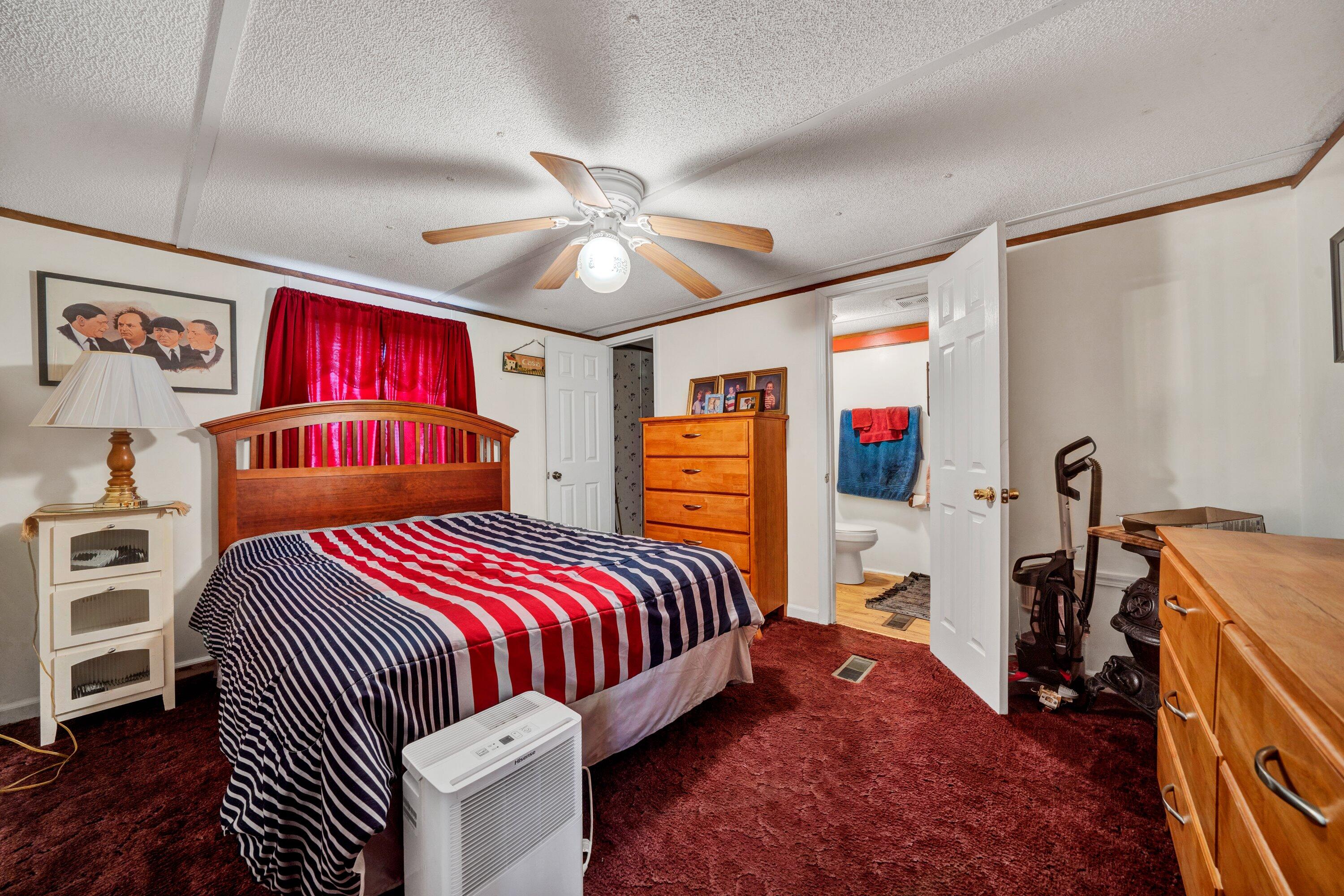 706 Telegraph Road Henry, VA 24102 - Photo 13 of 17 a bedroom with a bed and dresser with wooden floor