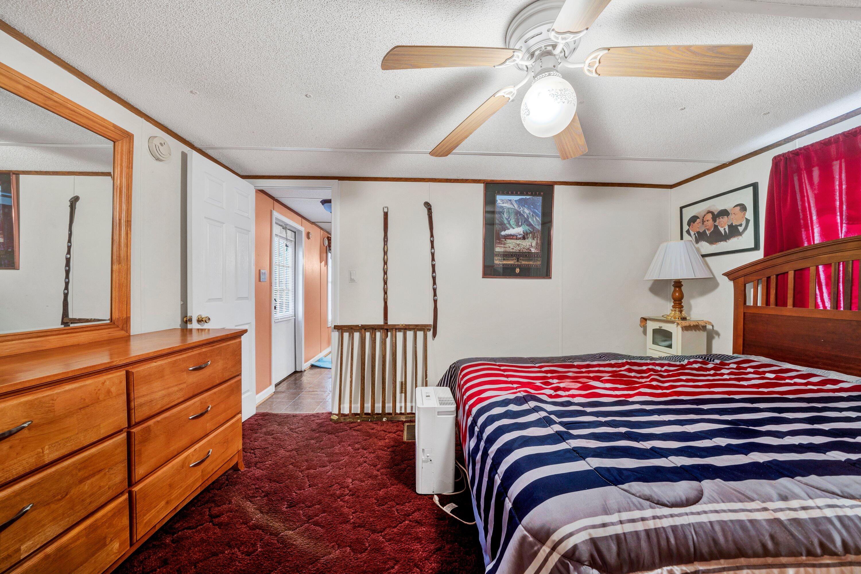706 Telegraph Road Henry, VA 24102 - Photo 14 of 17 a bedroom with a bed and a chandelier
