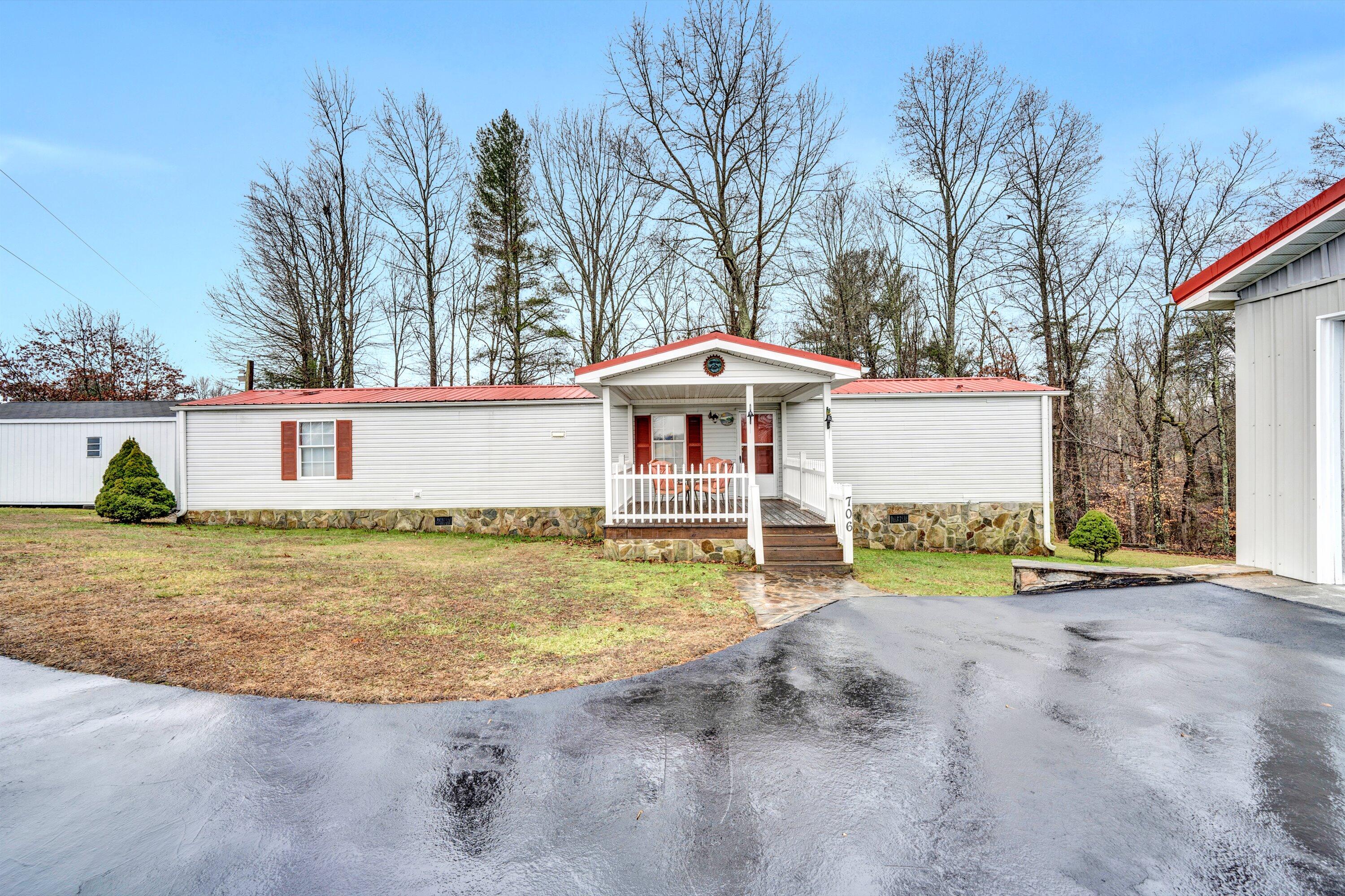 706 Telegraph Road Henry, VA 24102 - Photo 3 of 17 front view of a house with a yard table and chairs