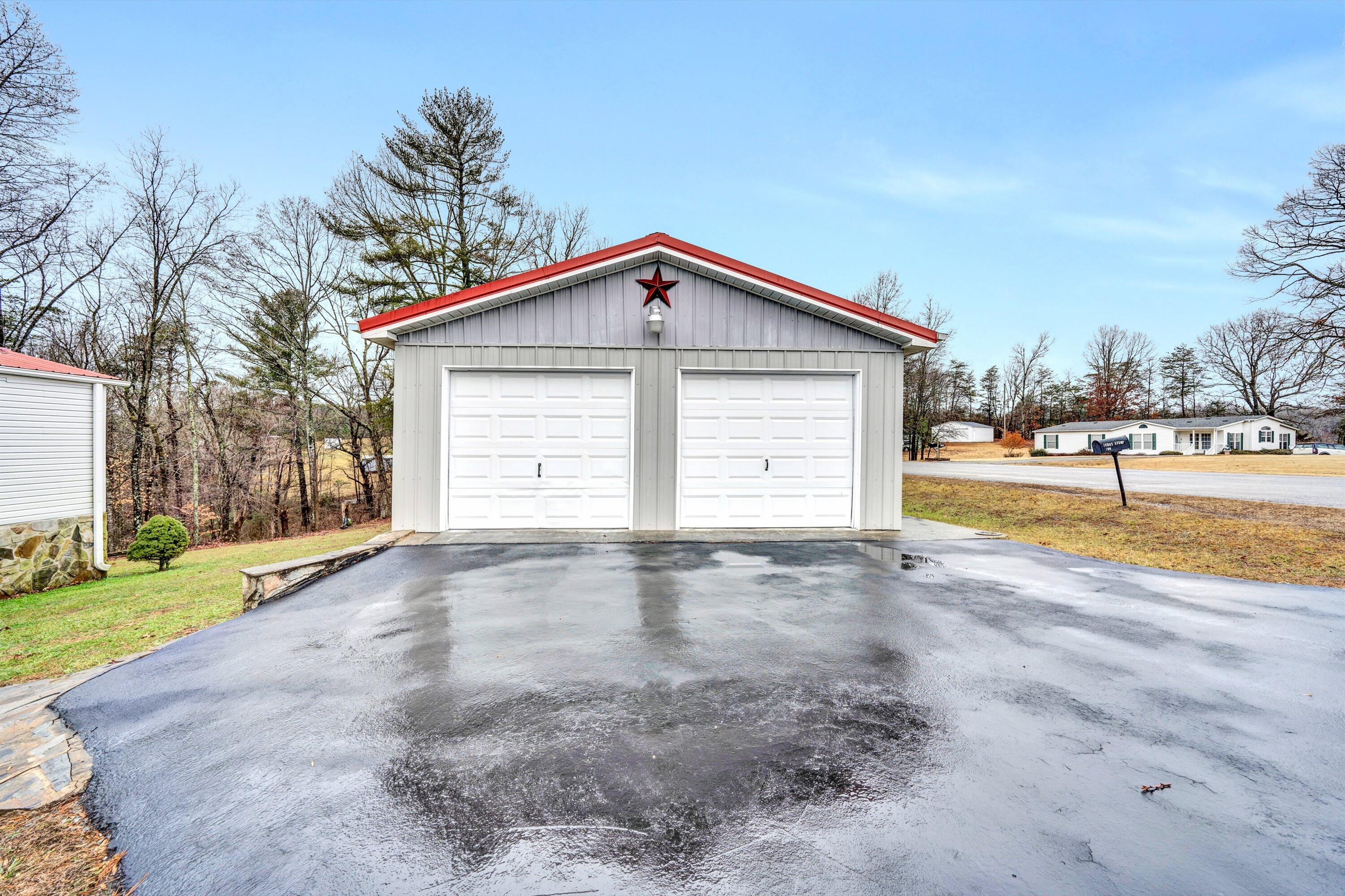 706 Telegraph Road Henry, VA 24102 - Photo 4 of 17 a view of a house with a yard and garage