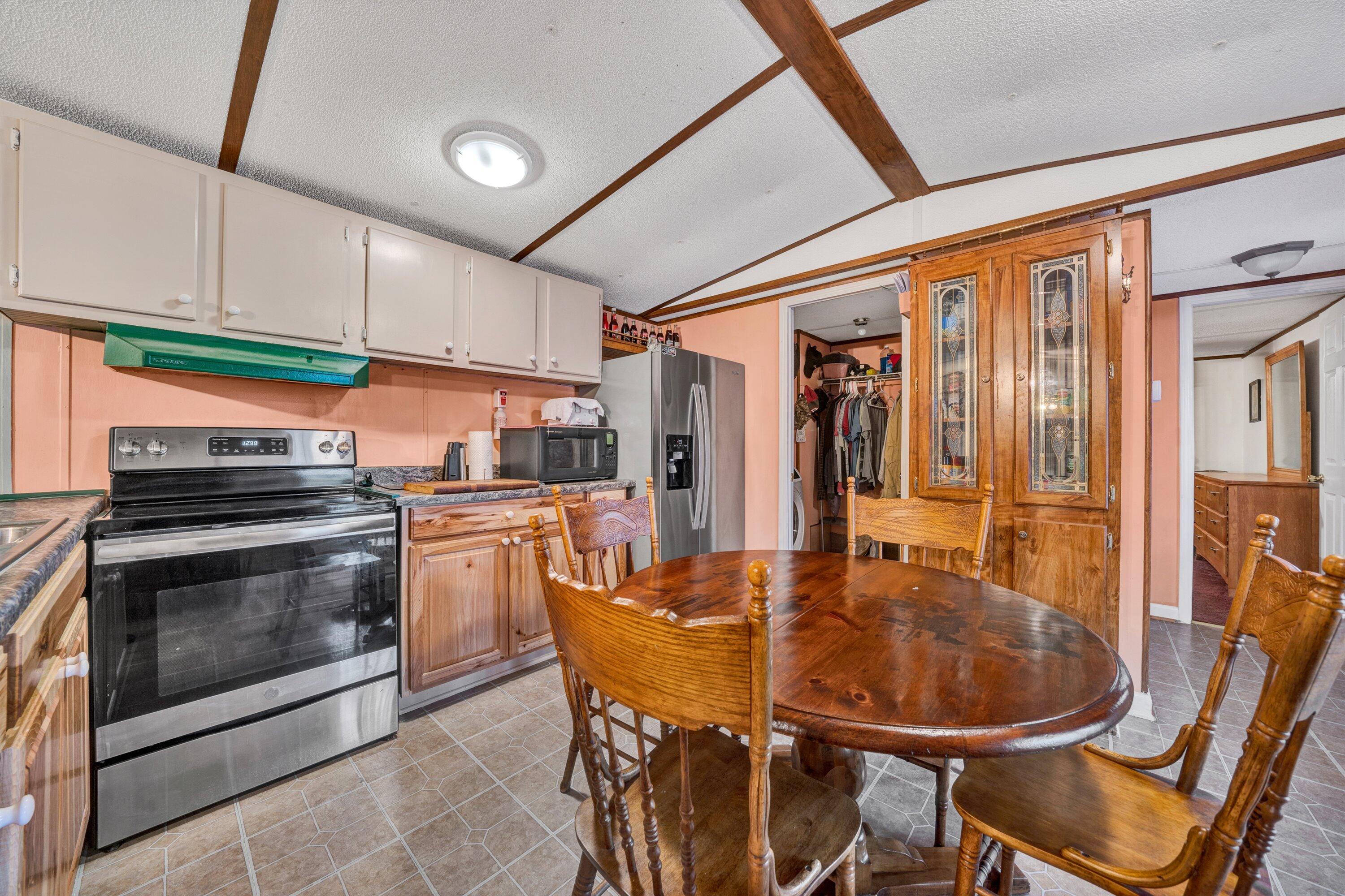 706 Telegraph Road Henry, VA 24102 - Photo 7 of 17 a kitchen with a table chairs stove and cabinets