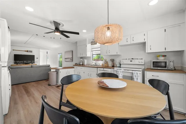 a kitchen with a dining table and chairs