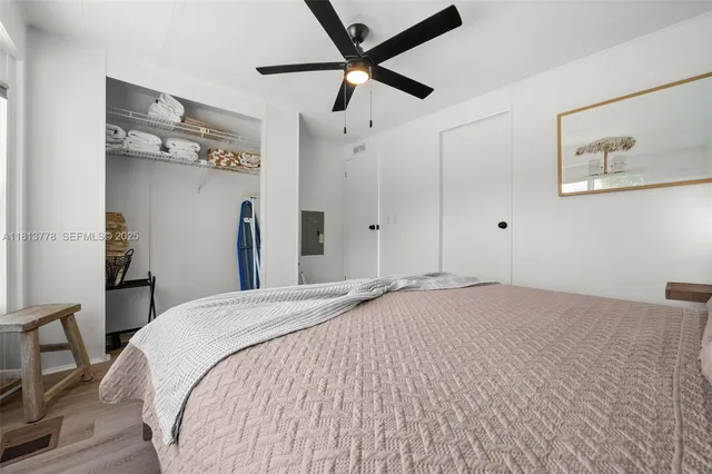 a bed room with a bed and a ceiling fan