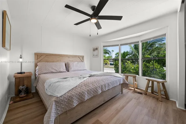 a bedroom with a bed and a large window