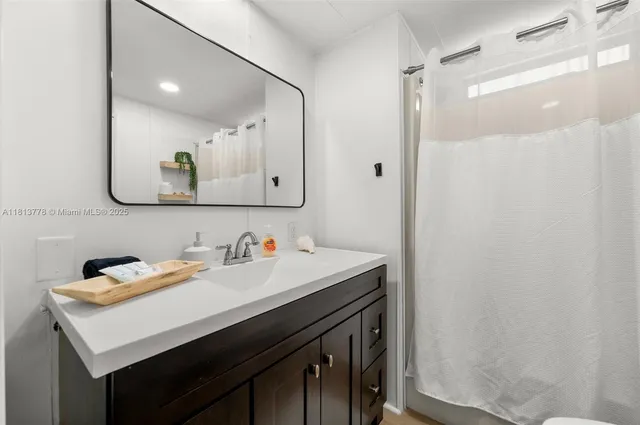 a bathroom with a sink vanity and a mirror