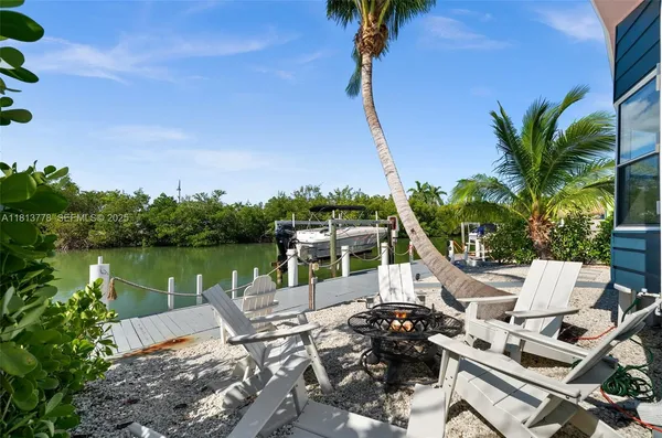 a view of a lake with a table and chairs