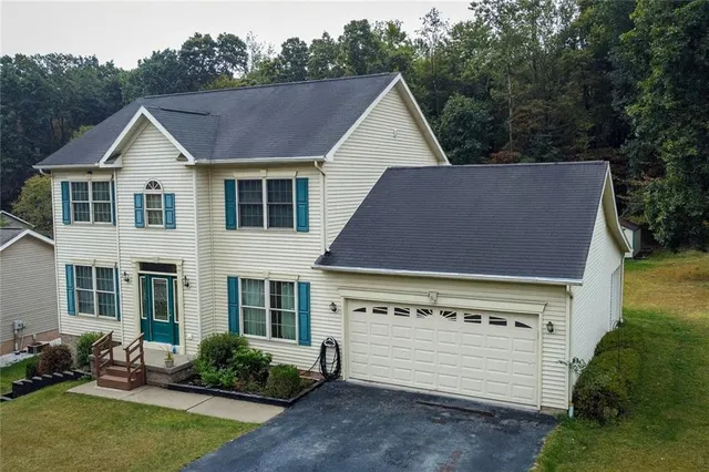 a view of a house with a yard and plants