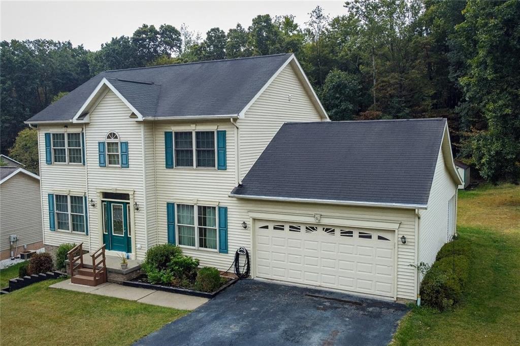 a view of a house with a yard and plants
