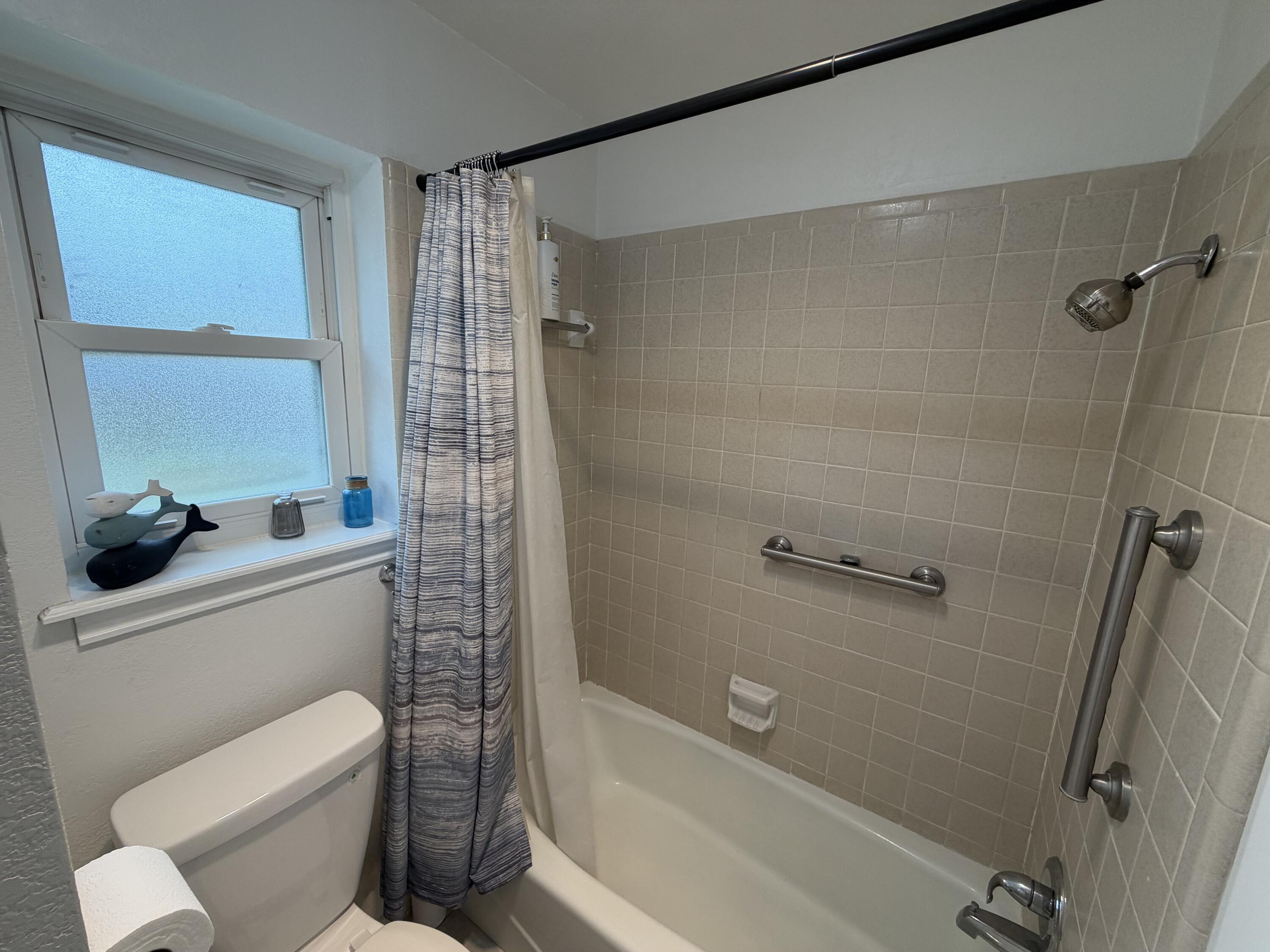 3236 94th Street Lubbock, TX 79423 - Photo 14 of 31 a bathroom with a toilet and a shower