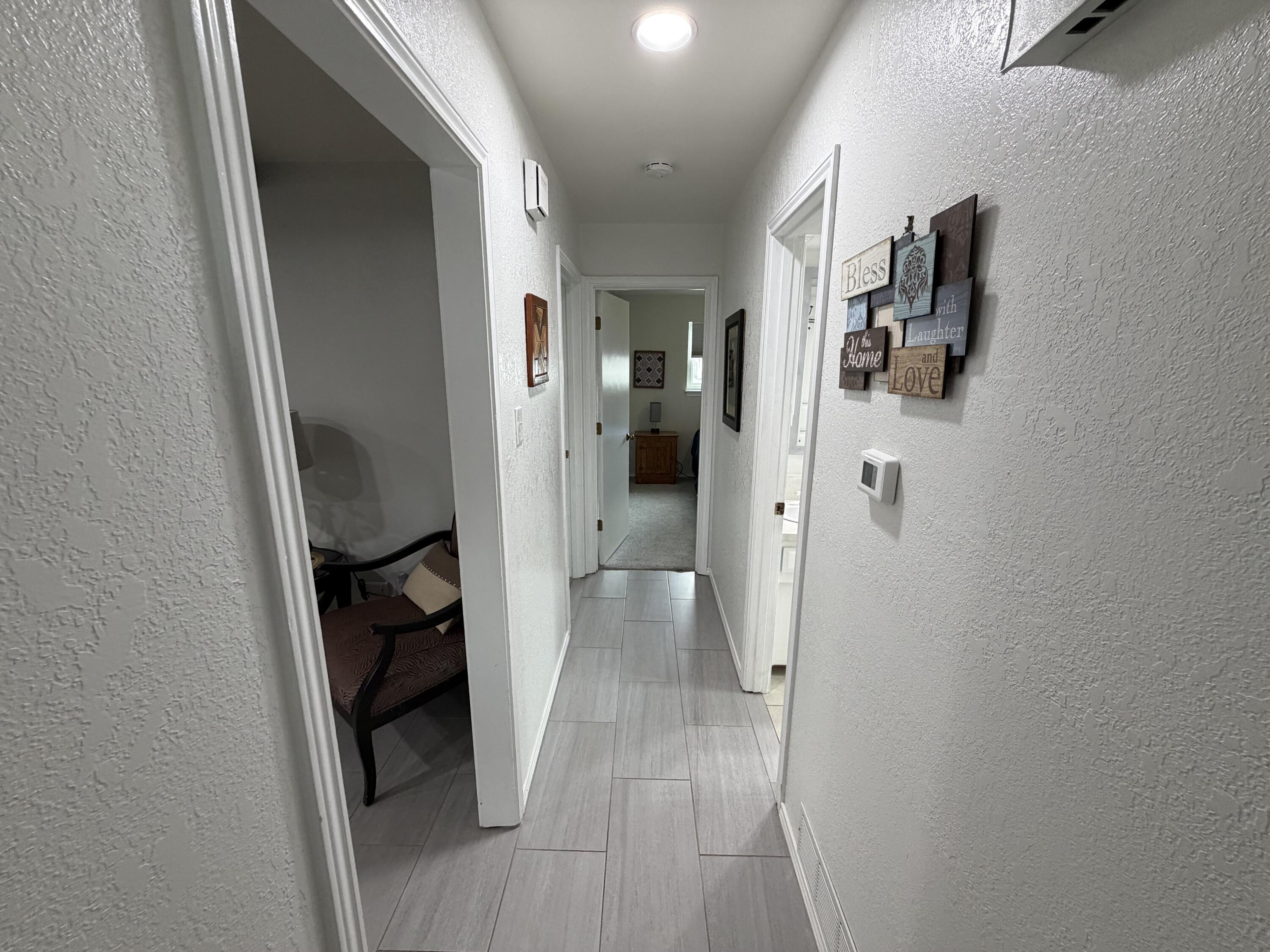 3236 94th Street Lubbock, TX 79423 - Photo 15 of 31 a view of a hallway and wooden floor windows and a bathroom