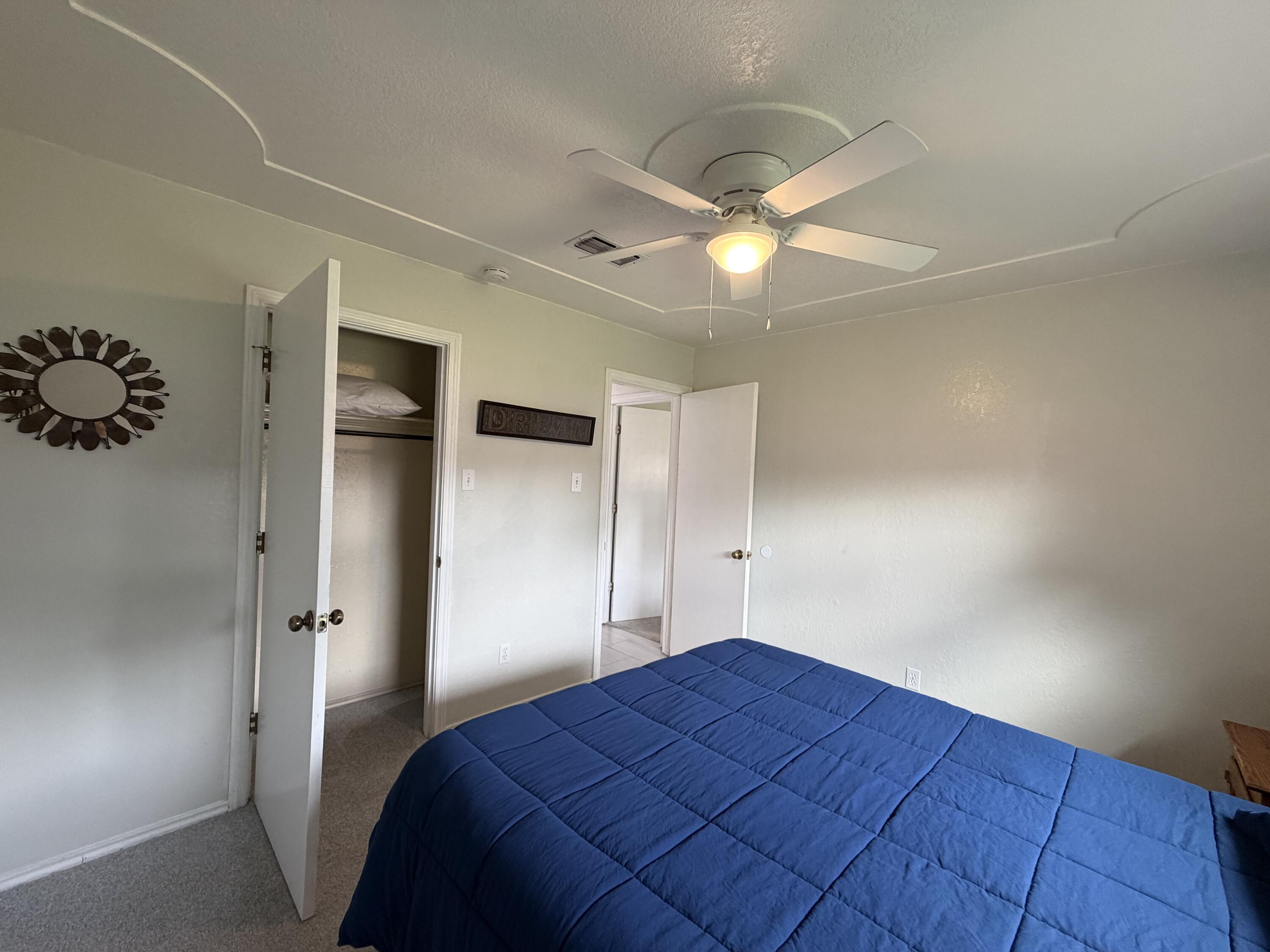 3236 94th Street Lubbock, TX 79423 - Photo 17 of 31 a bedroom with a bed and a window