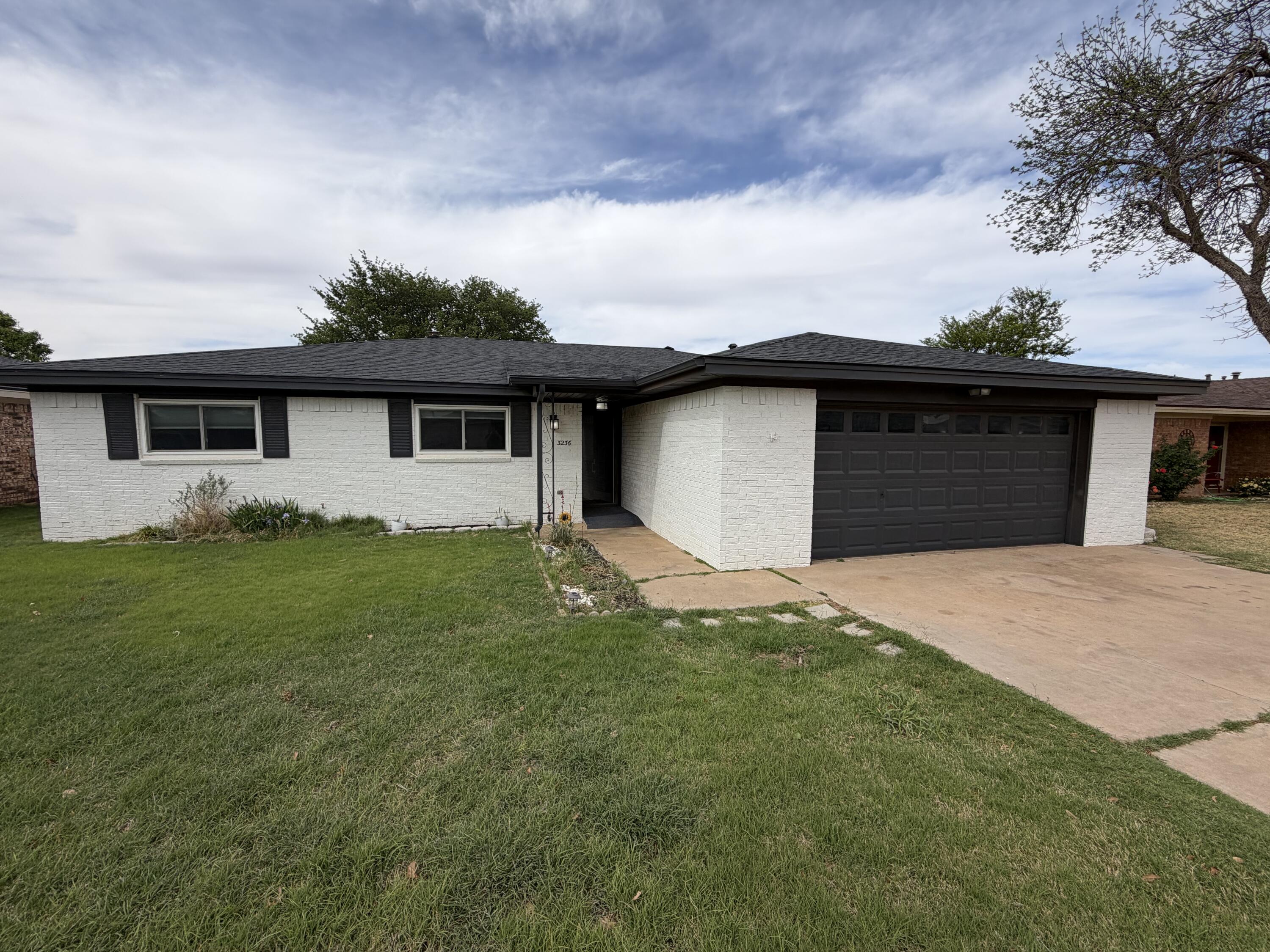 3236 94th Street Lubbock, TX 79423 - Photo 2 of 31 a front view of house with yard and green space