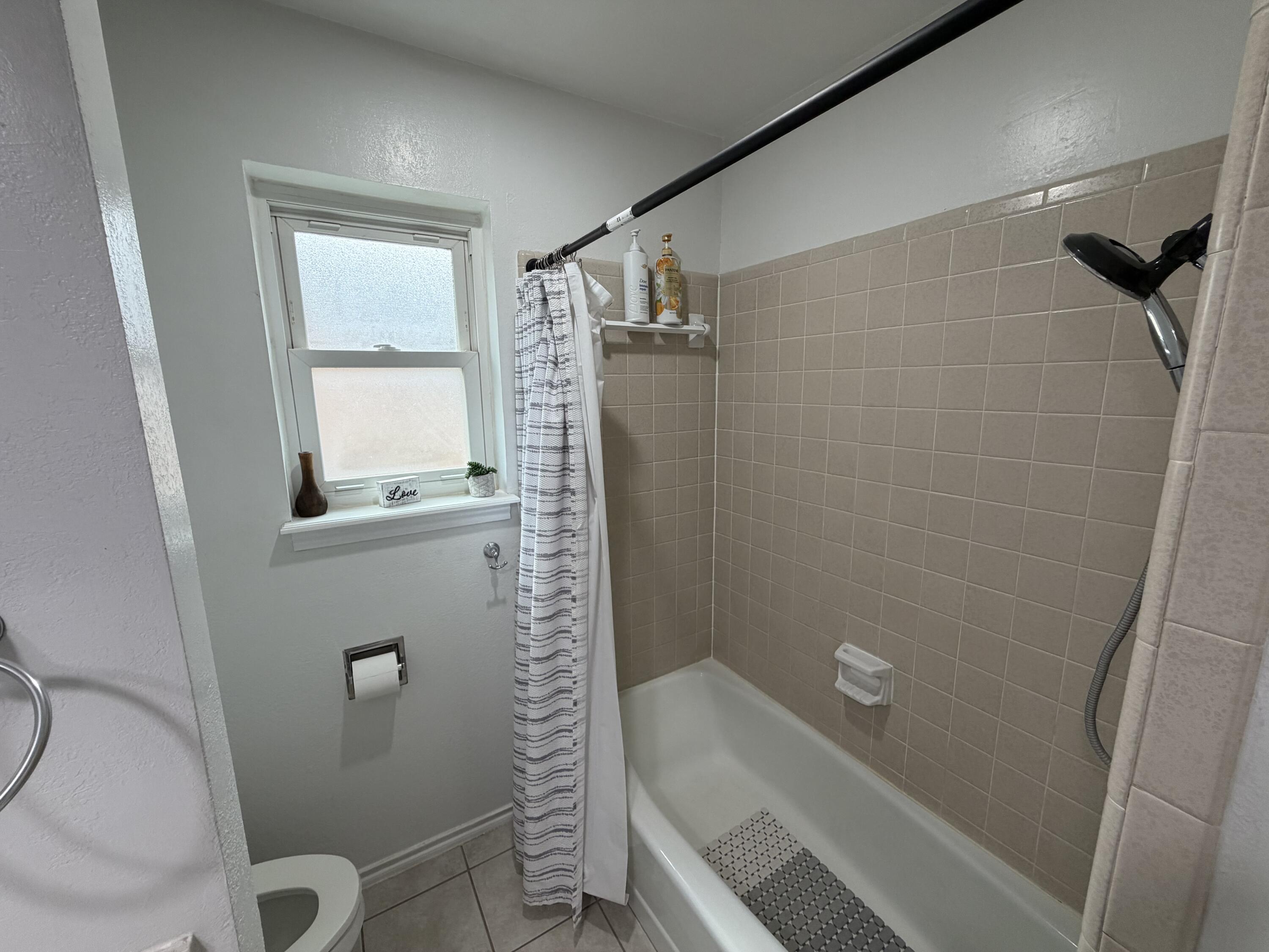 3236 94th Street Lubbock, TX 79423 - Photo 21 of 31 a bathroom with a shower and toilet