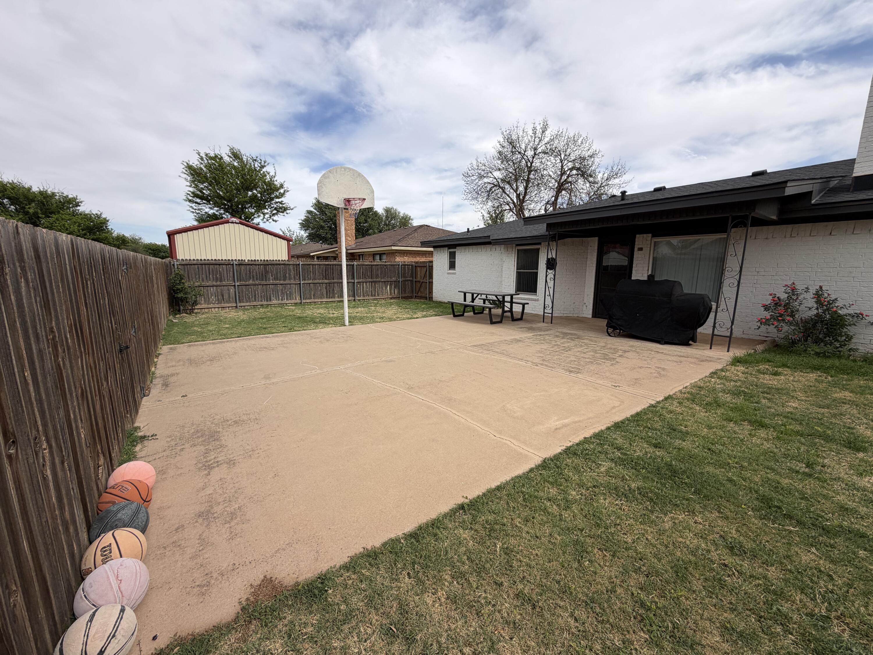 3236 94th Street Lubbock, TX 79423 - Photo 30 of 31 a backyard of a house with table and chairs
