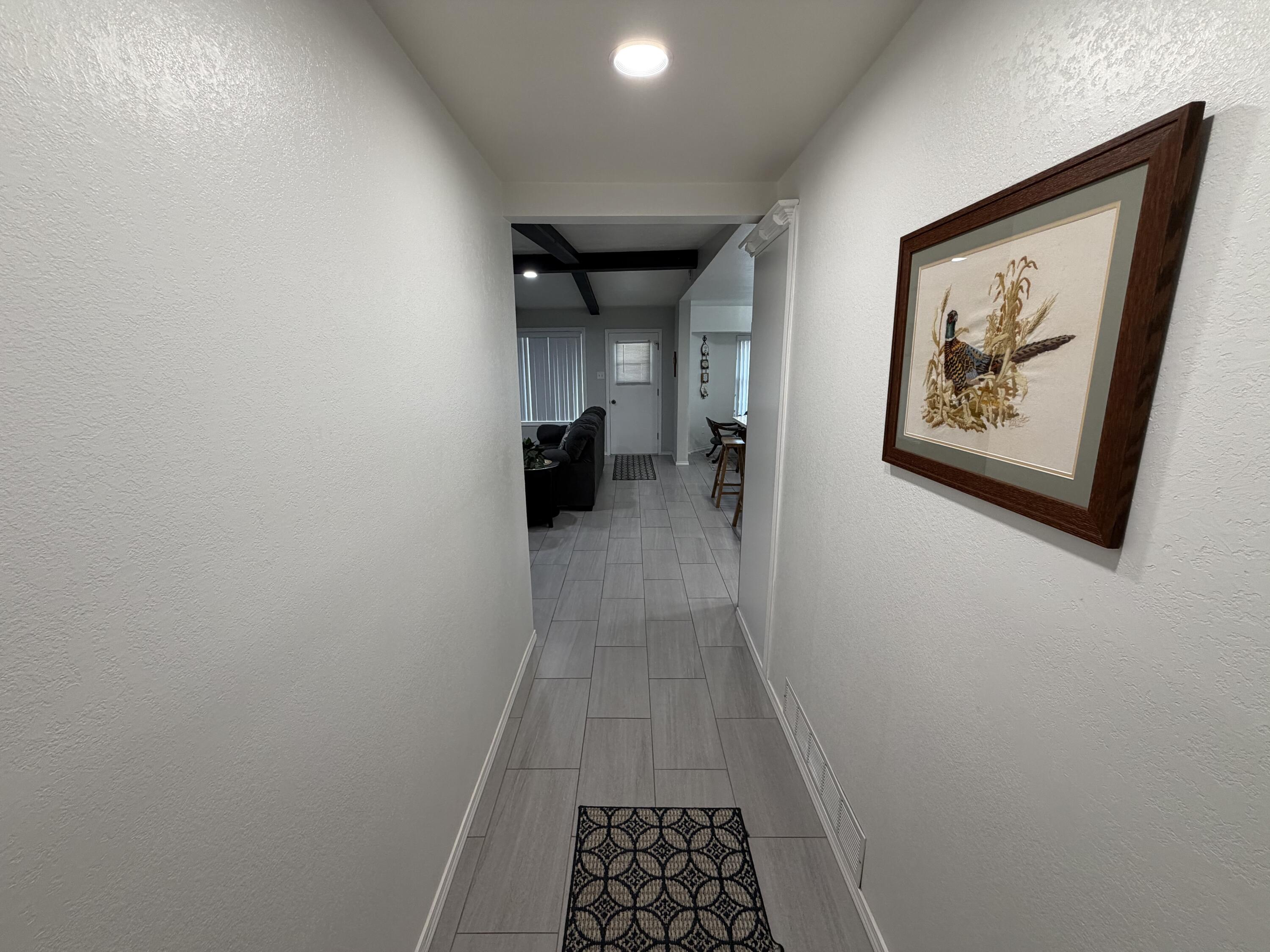 3236 94th Street Lubbock, TX 79423 - Photo 4 of 31 a view of hallway with wooden floor