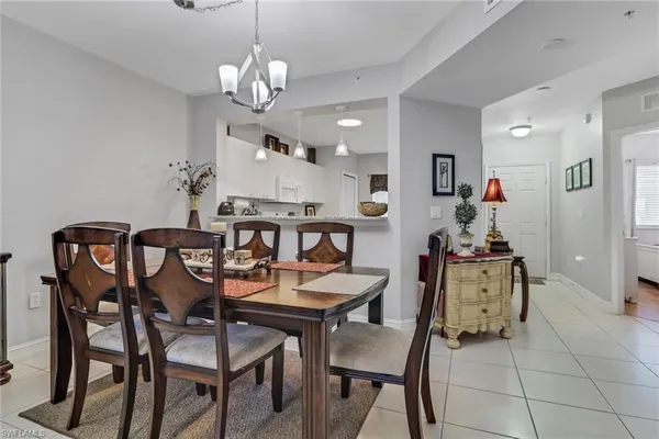 a view of a dining room with furniture and chandelier