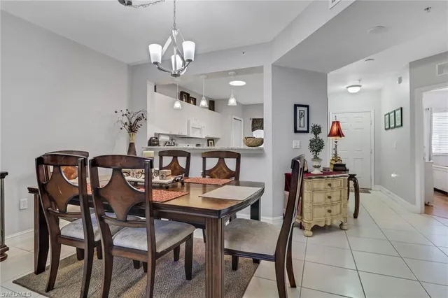 a view of a dining room with furniture and chandelier