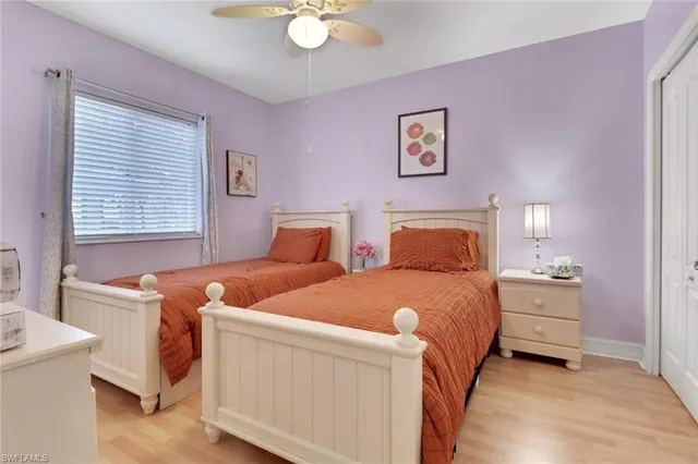 a bedroom with two beds and painting on the wall