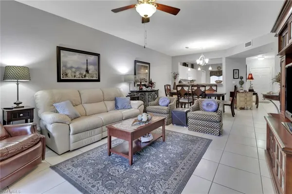 a living room with furniture and a chandelier