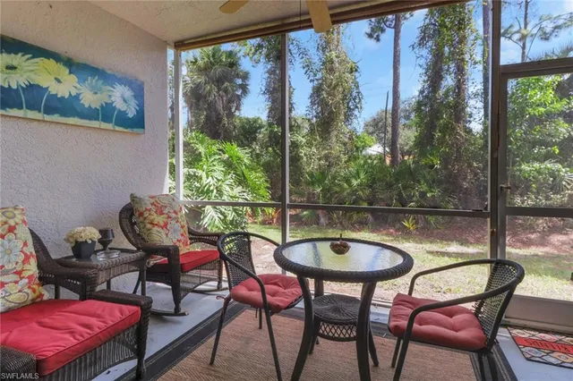 a dining room with furniture and a floor to ceiling window