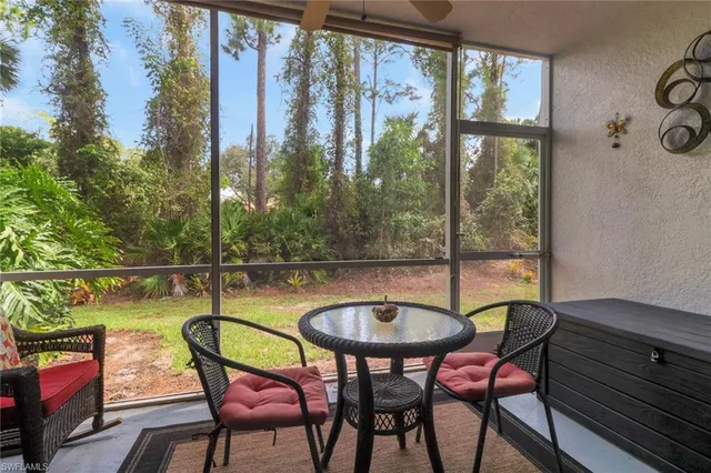 a dining room with furniture and a floor to ceiling window