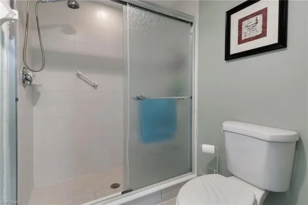 a white toilet sitting next to a bathroom sink