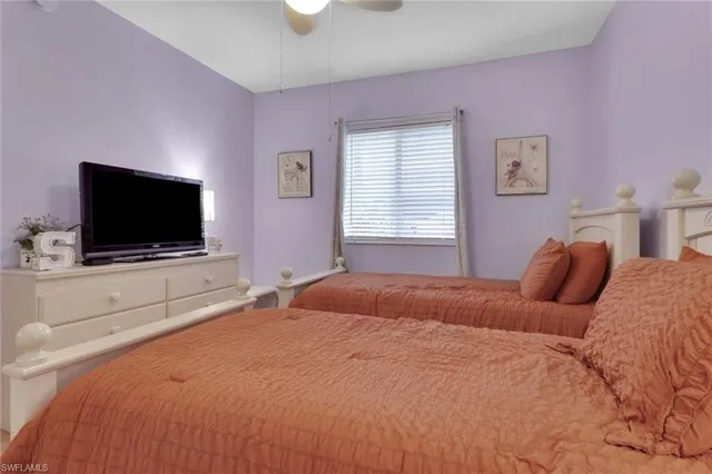 a bedroom with a flat screen tv and a bed