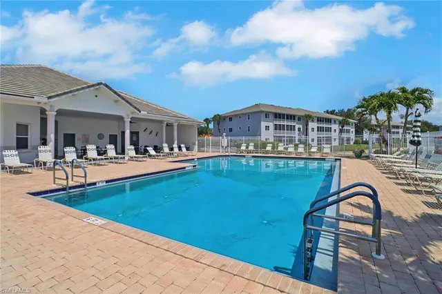 a front view of a house with swimming pool and sitting area