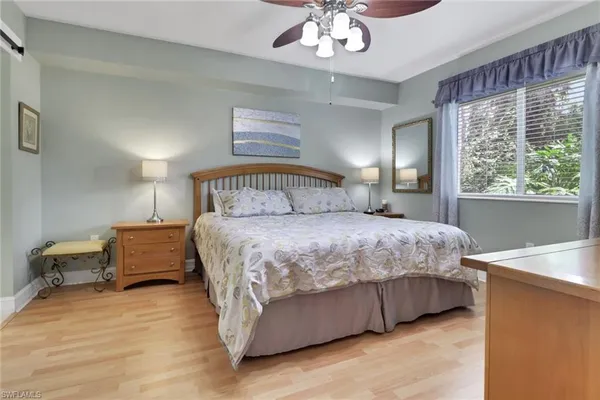 a bedroom with a large bed and a chandelier